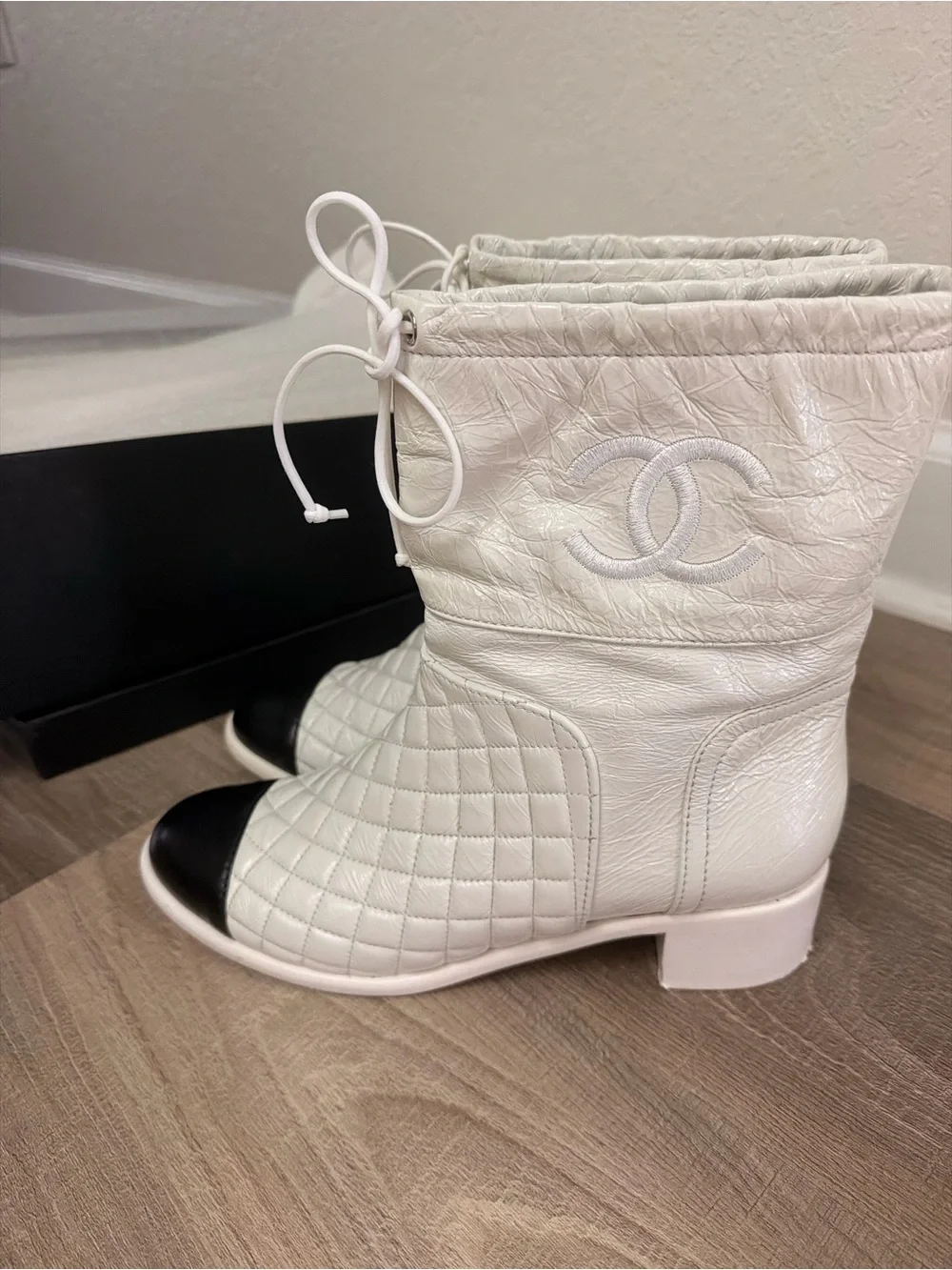 CHANEL White Quilted Leather Ankle Boots with Black Cap Toe and Drawstring